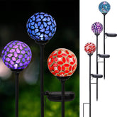 Afirst mosaic ball light with crackle glass reflecting sun colors along the garden path.