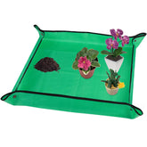 Azureblue repotting mat in use catching soil during indoor potting