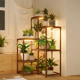 Bamworld plant stand with grow light in a corner for thriving indoor greenery.