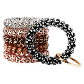 BIHRTC spiral wristband worn as a keychain for easy access during workouts.