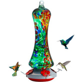 Birdkiss glass hummingbird feeder outdoors with bright colors attracting birds.