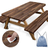 Britown picnic table cover with elastic edges on brown wood beside a campsite