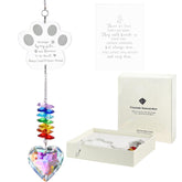 Ceegook dog memorial crystal suncatcher paw motif reflects rainbow light in sun