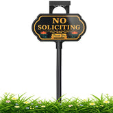 CKOK solar no-soliciting sign with floral panel lights after dark for visibility.