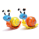 Cruis Cuka snail garden decor in yellow enhances sunny patios with curb appeal