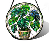 DASTOLL stained glass window hanging green Monstera suncatcher catches sunlight to brighten a room.