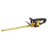 DEWALT DCHT821B hedge trimmer in hand for precise trimming task.