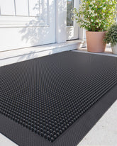 DEXI front door mat with fingertip pattern traps dirt at the entryway.