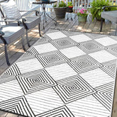 DiiKoo waterproof outdoor rug 6x9ft folded in carry bag for travel.