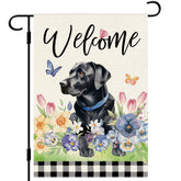Dlzdn Spring Dog Flag with black Labrador and floral motif adorning a sunny entryway.