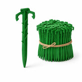 Ecoduty biodegradable 4inch stake securing landscape fabric in soil.