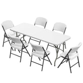 Elevon six-ft folding table with white chairs ready for outdoor event use