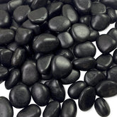 FANTIAN 5 lbs black pebbles in a planter, enhancing soil appearance and drainage.