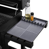 Find Law griddle mat on side shelf organizes utensils.