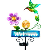 FOMOMDI outdoor solar garden stake with welcome sign and hummingbird ornament lights the pathway.