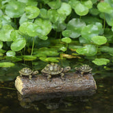 Generic Three Turtle Floating Sculptures resting on a log add natural pond charm.