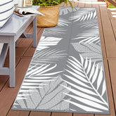 GENIMO outdoor rug with palm leaf front pattern, ideal for patio styling and durable outdoor use.