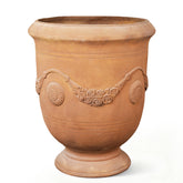 Greens Word planter-urn rust-color finish enhances curb appeal and front porch decor.