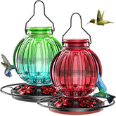Grete Gotye glass hummingbird feeder in outdoor color scheme for year-round use