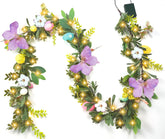 Gudegou 6FT Easter garland on mantel with butterflies and flowers for spring charm.
