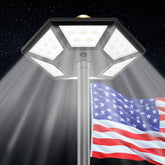 Hainee flag pole light top-mount close-up showing solar panel and lens for dusk-to-dawn illumination
