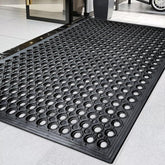 Halidec outdoor rubber mat with drainage holes improves wet area safety.