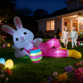 Hamito 12ft giant Easter bunny inflatable lying for a striking outdoor display at night with LED glow.