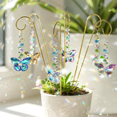 H&D HYALINE & DORA butterfly crystal suncatcher stake captures sunlight to create rainbow prisms.