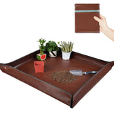 HNXTYAOB potting mat laid out for spacious workspace with large plants.
