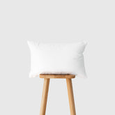 Hofdeco Premium lumbar pillow insert on outdoor chair delivering supportive comfort outdoors.