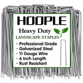 HOOPLE landscape staples driven into soil for secure weed barrier fabric.