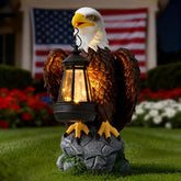 Jesokiibo USA Bald Eagle statue with solar light illuminating your yard at dusk.