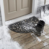 Kempf rubber scroll doormat at front door with secure grip and dirt-trapping design.