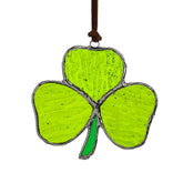 KRISININE shamrock sun catcher in a window creates rainbow reflections for home charm.