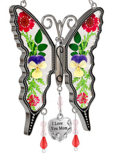 KY&BOSAM butterfly suncatcher window display with real dried flowers catching sunlight.