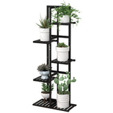 Laiensia five-tier bamboo plant stand displaying six pots on a patio.