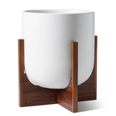 LE TAUCI 12-inch plant pot with wood stand for elevated indoor display.