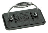 Lodge grill press with cool-grip spiral handle for safe, comfortable burgers on the stovetop.