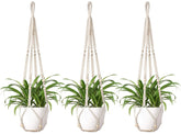 Mkono macrame plant hanger ivory with wood beads adds boho chic to indoor spaces.