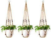 Mkono macrame plant hanger with wood beads enhances rustic decor in any room.