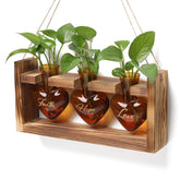 MTsigns plant terrarium heart vase on wooden stand enhances desk decor.