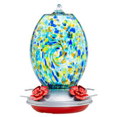 Muse Garden Starry Night 27oz hummingbird feeder glistens in sunlight, inviting hummingbirds to sip nectar.