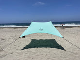 Neso portable beach tent seafoam provides lightweight shade for family days by the shore.