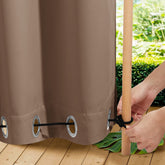 NICETOWN outdoor curtains on a pergola provide privacy and shade in tan-khaki fabric