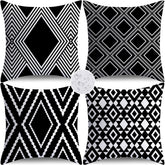 Nightwish outdoor pillow cover with black geometry on a patio, water-repellent and durable.