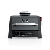 Ninja Woodfire Grill on an outdoor patio shows all-in-one versatility for outdoor cooking.