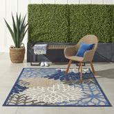 Nourison Aloha floral pattern close-up in blue and multi colors for outdoor use