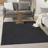 Nourison Essentials Black 5x7 area rug for versatile indoor-outdoor use with a soft underfoot.