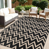 OLANLY waterproof outdoor rug 5x8 ft in black and beige on patio, ideal for decks and balconies.