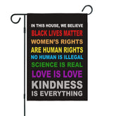 OUXIOAZ Pride flag garden banner This House We Believe design displayed outdoors.